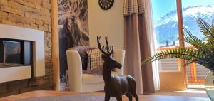 a statue of a deer on a table in a living room at Kienberg in Pfronten