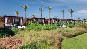 a row of modular homes with palm trees in the background at Kempinski Summerland Hotel & Resort Beirut in Beirut