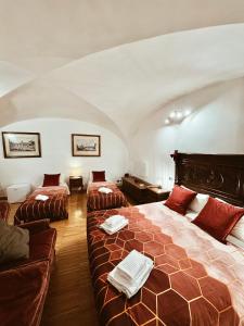 a bedroom with a large bed and a couch at Residenza Tritone Luxury Guest House Trevi Fountain in Rome