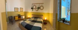 a bedroom with a bed and a desk with two candles at Bari Holiday Garibaldi 74 in Bari