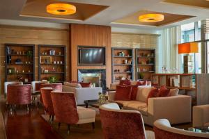 a living room with couches and chairs and a fireplace at Kempinski Hotel Adriatic Istria Croatia in Savudrija