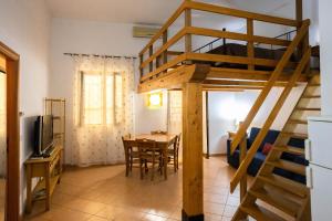 a room with a loft bed and a dining table at Hola Cathedral House in Palermo
