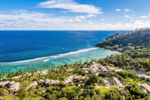 an aerial view of the beach and the ocean at Kempinski Seychelles Resort in Baie Lazare Mahé