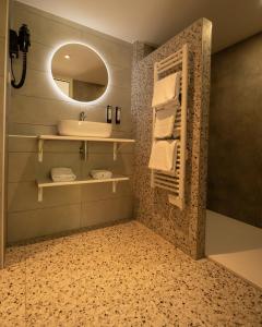 a bathroom with a sink and a mirror at Kyriad Lyon Sud Sainte Foy in Sainte-Foy-lès-Lyon