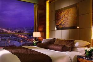 sypialnia z dużym łóżkiem i dużym oknem w obiekcie Kempinski Hotel Yinchuan w mieście Yinchuan