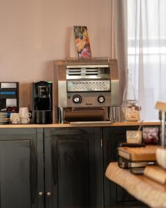 a kitchen with a toaster oven on top of a counter at Kyriad Lyon Sud Sainte Foy in Sainte-Foy-lès-Lyon