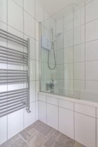a bathroom with a shower and a sink at GuestReady - Glasnevin Charm near DCU in Dublin