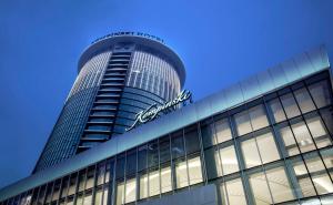 a tall building with a sign on top of it at Kempinski Hotel Taiyuan in Taiyuan