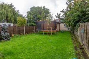 a small garden with a table and a fence at GuestReady - Glasnevin Charm near DCU in Dublin