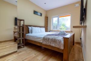 a bedroom with a bed and a tv and a window at GuestReady - Glasnevin Charm near DCU in Dublin