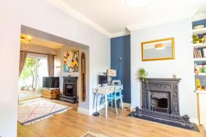 a living room with a fireplace and a desk at GuestReady - Charming House in East Wall in Dublin