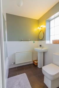 a bathroom with a toilet and a sink at GuestReady - Charming House in East Wall in Dublin