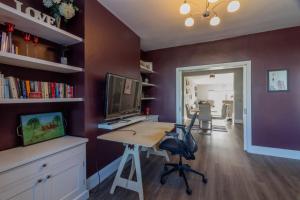 a room with a desk with a computer and a tv at GuestReady - Restful stay in Drimnagh in Crumlin