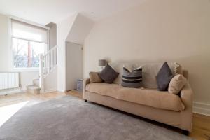 a living room with a couch with pillows on it at GuestReady - Cosy Retreat in Donnybrook in Dublin