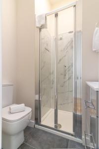 a bathroom with a shower and a toilet at GuestReady - Cosy Retreat in Donnybrook in Dublin