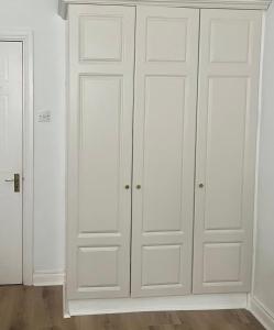 a white closet with white cabinets in a room at GuestReady - Lovely stay in Dublin in Dublin