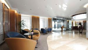 a lobby with chairs and a table in a building at Kempinski Hotel Khan Palace in Ulaanbaatar