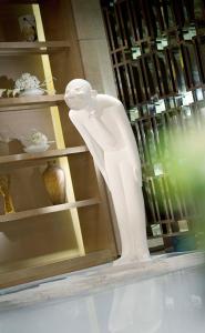 a white statue in a display case in a store at Kempinski The One Suites Hotel Shanghai Downtown in Shanghai