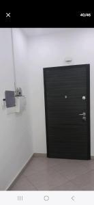 a black door in the corner of a room at Anaelle in Birmandreis