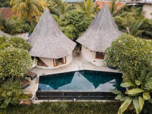 an aerial view of a resort with a swimming pool at The Sender Pool Suites in Ubud