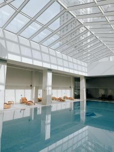 a swimming pool with a glass ceiling in a building at Luxury apartment in Skopje in Skopje