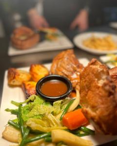 a plate of food with vegetables and a dipping sauce at The Squirrel in Godalming