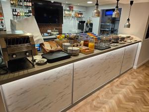 a kitchen counter with a buffet of food on it at ibis budget Derby in Derby
