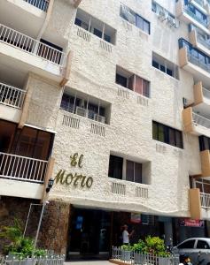 a building with the name of a hotel at El Morro Beach 2 in Santa Marta