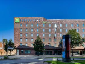 a large brick building with a sign on it at ibis Styles Hamburg Barmbek in Hamburg