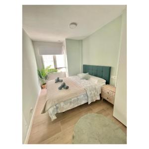 Łóżko lub łóżka w pokoju w obiekcie Pontevedra Apartments - Peregrina Family Suite