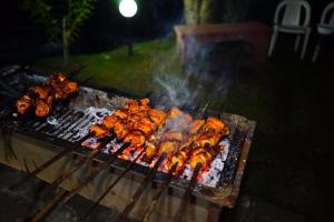 a grill with a bunch of food on it at Bhurban Valley Cottages 3 in Bhurban