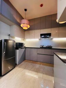 a kitchen with a stainless steel refrigerator at Villa Aqua WIth Swimming Pool in Lucknow