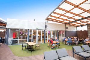 a group of people sitting at tables on a patio at Nightcap at Roxby Downs in Roxby Downs