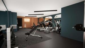 a gym with treadmills and ellipticals in a room at Doubletree By Hilton Sheffield City in Sheffield