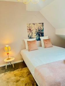 1 dormitorio con 2 camas y mesa con lámpara en Magnifique maison de ville en Morestel