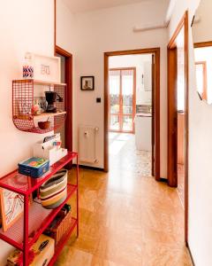 a room with a red shelf and a hallway at [Free Parking] Un angolo di sole a MareBu! in Rapallo