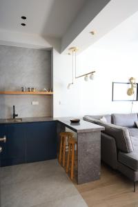 a kitchen and living room with a couch and a table at One Apartment by Skg Apartments in Thessaloniki