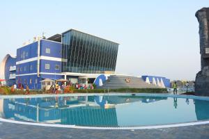 a large swimming pool in front of a building at Silver Stone Park Resort, Kovilpatti in Kovilpatti