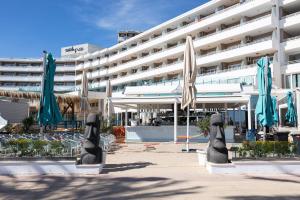 a hotel with closed umbrellas in front of a building at My Sea view - Magaluf in Magaluf