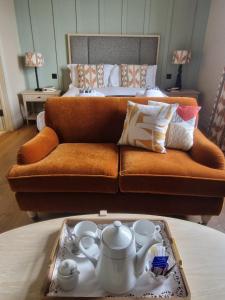 a living room with a couch and a table with a tray at Redcliffe Hotel in Paignton