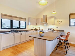 a kitchen with white cabinets and a island with a bowl on it at 2 Bed in Somerton 92126 in Babcary