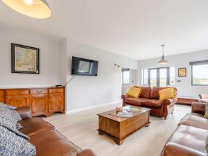 a living room with a couch and a coffee table at 4 Bed in Maresfield 56696 in Maresfield
