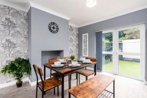 a dining room with a table and chairs at Stylish House with Garden in Knottingly