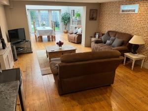 a living room with a couch and a table at Large 2-Bed House Derbyshire off Chatsworth rd in Chesterfield