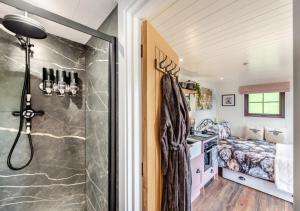 a bathroom with a shower in a tiny house at Little Bo Peep in Fremington