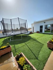 a backyard with a trampoline on the grass at Piscine privative et prestations haut de gamme in Dakar