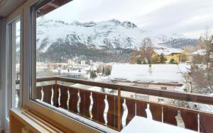 a balcony with a view of snow covered mountains at Sonnalpine A20 in St. Moritz