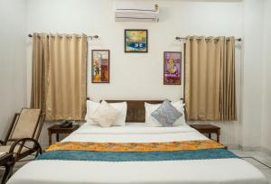 a bedroom with a large bed and curtains at Tripli Hotels GADH BANSIYA in Udaipur