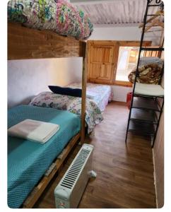 a room with two bunk beds and a ladder at Casa rural privada in Orihuela