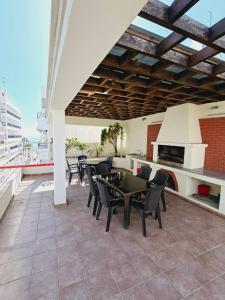 a patio with a table and chairs and a kitchen at Stephanie City Apartments in Larnaka